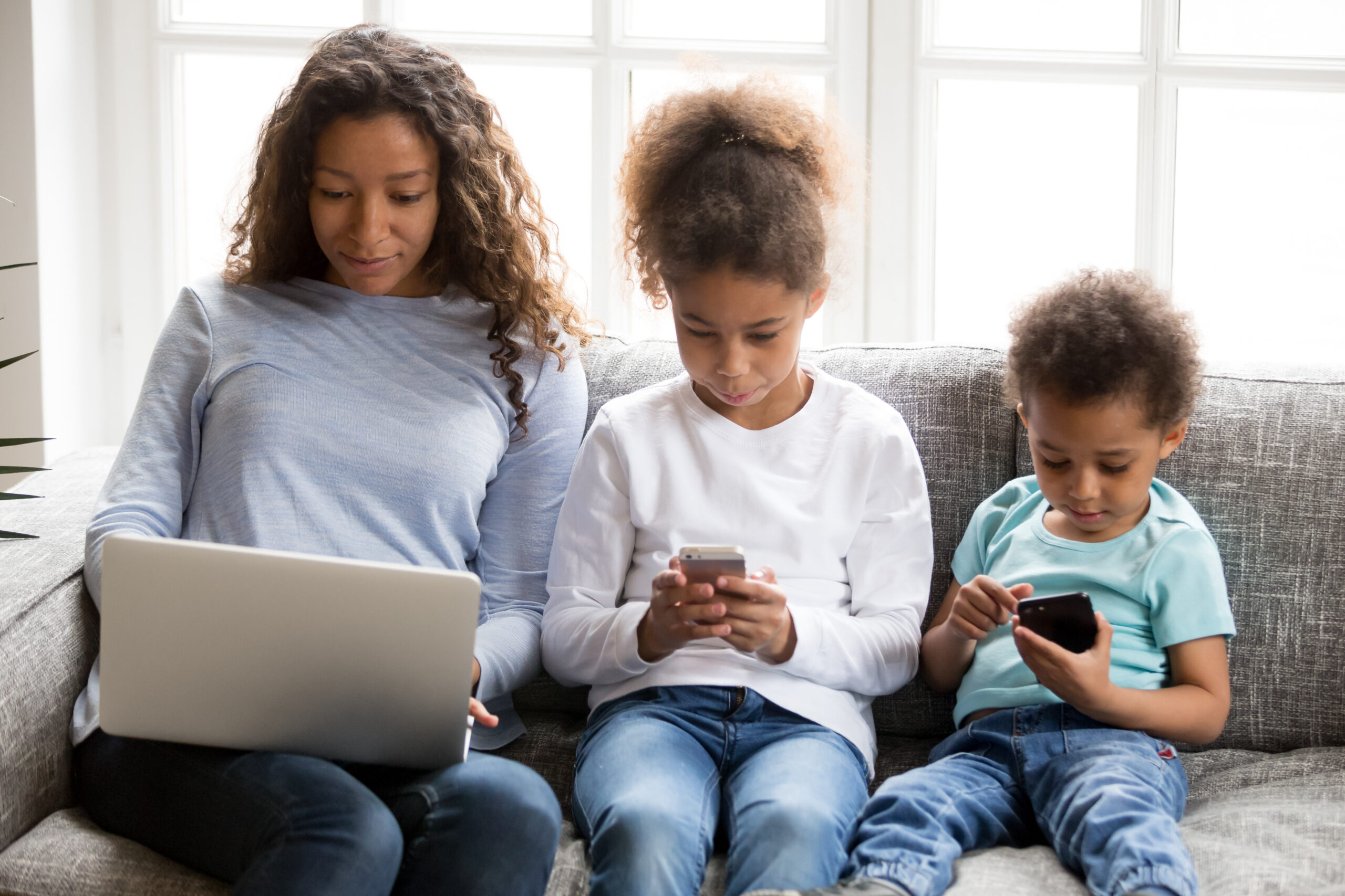 Family using tech devices simultaneously